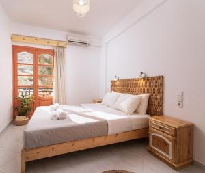 a bedroom with a large bed and a window at Amalia in Matala