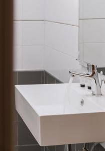 a white sink in a bathroom with a mirror at Amalia in Matala