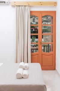 a room with a bed with two towels on it at Amalia in Matala