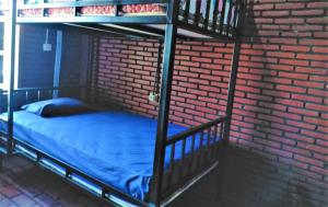 מיטה או מיטות בחדר ב-Kendang Kempul Hostel