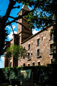 a large brick building with a tower on top of it at Casa Rural Los Lilos in Gotor