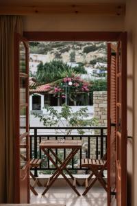 a table and chairs on a balcony with a view at Amalia in Matala