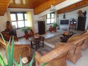 a living room with chairs and a table and a tv at Roc Heights in Bakau