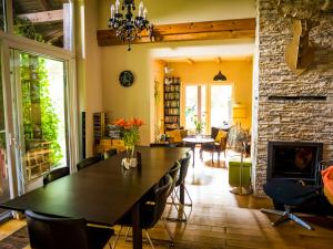 a dining room with a table and chairs and a fireplace at Willa tuŻur in Osie