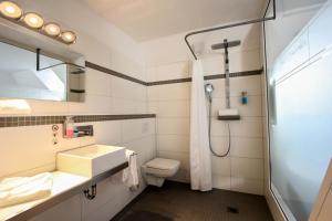 a bathroom with a sink and a toilet and a shower at SOLEWERK Hotel in Bad Salzungen