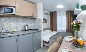 a small kitchen and a bedroom with a bed at Апартаменти MYFREEDOM поруч із метро Кловська in Kyiv