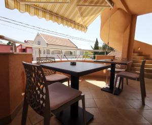 a patio with a table and chairs on a balcony at Apartments Montenegrina in Ulcinj