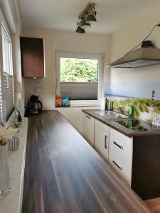 cocina con encimera de madera y ventana en Casa Auszeit en Oranienburg