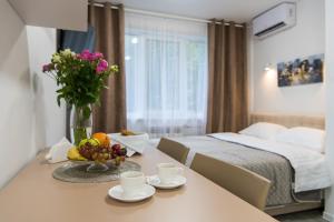 a bedroom with a bed and a table with a bowl of fruit at Апартаменти MYFREEDOM поруч із метро Кловська in Kyiv