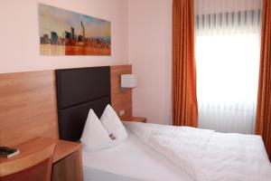 a hotel room with a bed and a window at Hotel Hübler in Frankfurt/Main +42 photos
