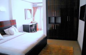 a bedroom with a bed and a window and a desk at Park Hotels in Port Harcourt
