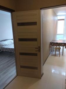 drzwi w pokoju z łóżkiem i stołem w obiekcie Квартира в ЖК Атриум w mieście Irpień