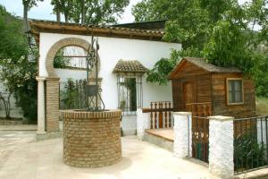 a house with a fence and a dog house at Casa Rural Arados in Priego de Córdoba