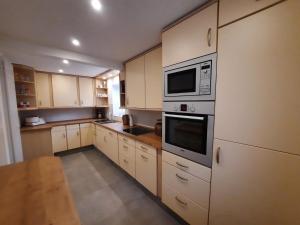 a large kitchen with white cabinets and appliances at Haus Chiara in Bad Kissingen