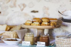 a table with a tray of pastries and jars of honey at Z Boutique Hotel in Panormos Rethymno