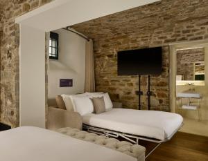 A bed or beds in a room at Bodmin Jail Hotel