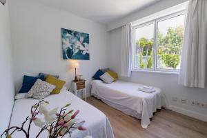 a room with two beds and a window at Villa Flamingos Marbella in Marbella +32 photos