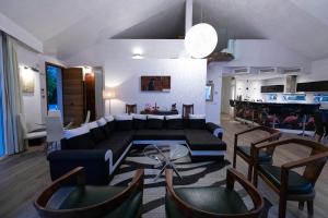 a living room with a couch and some chairs at Villa Flamingos Marbella in Marbella