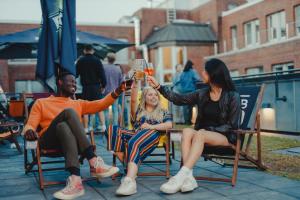 a group of people sitting in chairs holding up drinks at CAB20 in Hamburg
