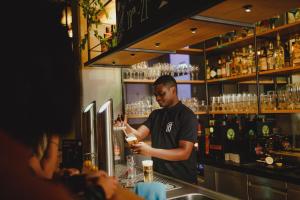 a man standing behind a counter at a bar at CAB20 in Hamburg