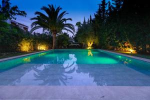a swimming pool at night with trees and lights at Villa Flamingos Marbella in Marbella