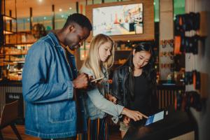 a man and two girls looking at a laptop at CAB20 in Hamburg