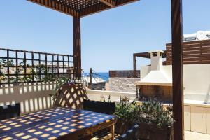 a patio with a table and a view of the ocean at Z Boutique Hotel in Panormos Rethymno