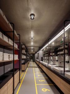 a long aisle of a store with sinks and mirrors at CAB20 in Hamburg