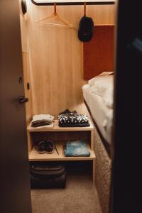 a room with a bed and a table with clothes at CAB20 in Hamburg