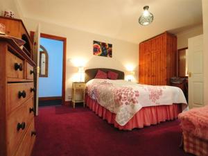 a hotel room with a bed and a dresser and a bedroom at Swallows Rest in Weymouth