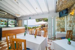 a restaurant with tables and chairs with a view of the ocean at Boutique & Beach Hotel Villa Wolff in Dubrovnik