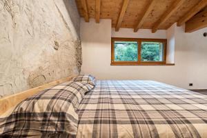 A bed or beds in a room at Casa al mulino