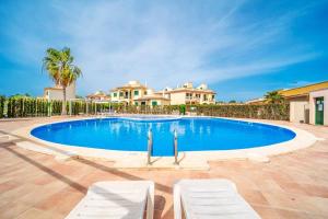 a swimming pool in front of a house at Residence El Paraiso in Sa Ràpita