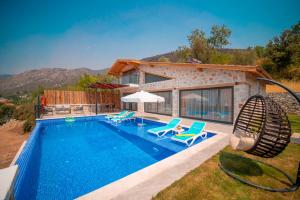 a villa with a swimming pool and a house at Elsu - 2 Bedroom Holiday Villa with jacuzzi in Kalkan in Çayköy