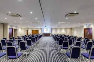 a conference room with chairs and a screen at Holiday Inn - Glasgow Airport by IHG in Paisley