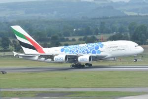 a blue and white airplane is on a runway at Holiday Inn - Glasgow Airport by IHG in Paisley