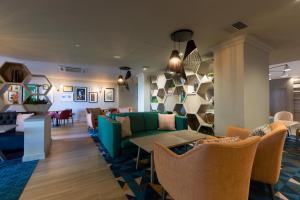 a living room with a green couch and chairs at Holiday Inn - Glasgow Airport by IHG in Paisley