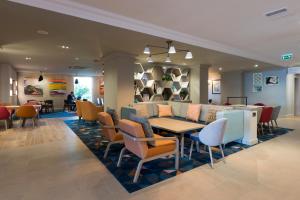 a dining room with a table and chairs at Holiday Inn - Glasgow Airport by IHG in Paisley