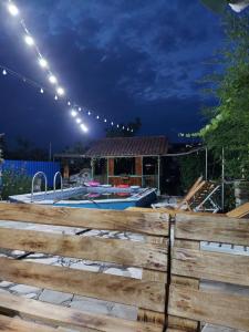 a backyard with a swimming pool and a wooden fence at Guest House Iura in Sighnaghi