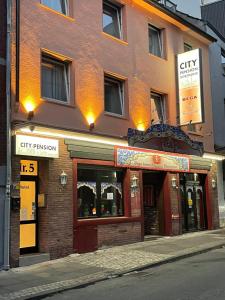 a brick building with a city pharmacy on a street at City-Pension-Dortmund in Dortmund