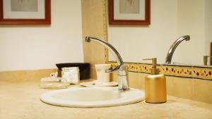 a sink with two faucets in a bathroom at בין האלונים in H̱arashim +16 photos