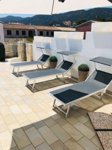 a group of lounge chairs sitting on a roof at Villa Melissa in Tertenìa
