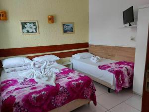 En eller flere senge i et værelse på Pousada Estrela Guia