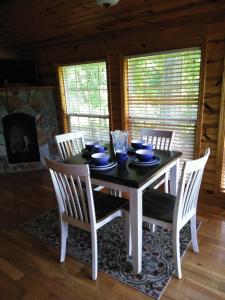 a dining room with a table and chairs and a fireplace at Magnificent views in Murphy in Murphy