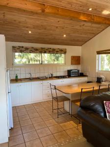 a kitchen with a table and chairs in a room at La Verdure Fruit Farm in Franschhoek