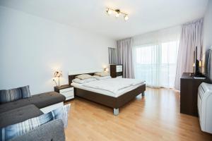 a large bedroom with a bed and a couch at Villa Grdelina in Supetar