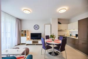 a kitchen and living room with a table and chairs at Villa Grdelina in Supetar