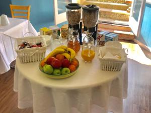 a table with a bowl of fruit and two baskets of honey at Highlea Guest House in Weston-super-Mare
