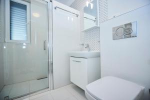 a white bathroom with a shower and a toilet at Villa Grdelina in Supetar +133 photos