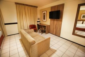 a hotel room with a couch and a bed at Holiday Inn Fortaleza by IHG in Fortaleza +114 photos
